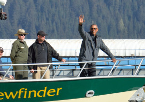 President Barack Obama waves to onlookers as the vessel Viewfinder disembarks for a tour of Resurrection Bay.