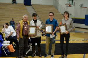 CIRI President and CEO Sophie Minich presented shareholder awards to Albert Harrison, Ryan Gump and Tamara Pickett at the Anchorage Potlatch. Photo by Jason Moore.