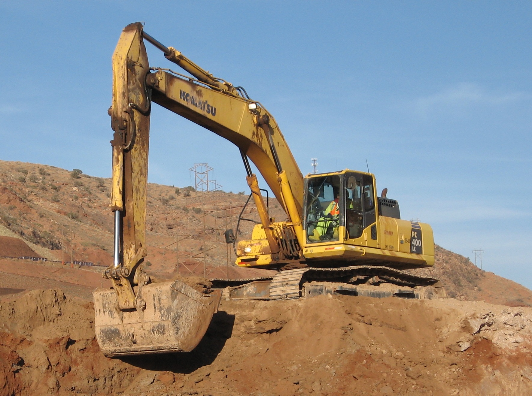 An excavator removes contaminants at a project site.