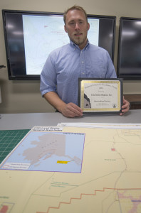 CIRI Surface Estate Manager Ben Mohr displays the "Outstanding Partner" award given to the company by the USFWS.
